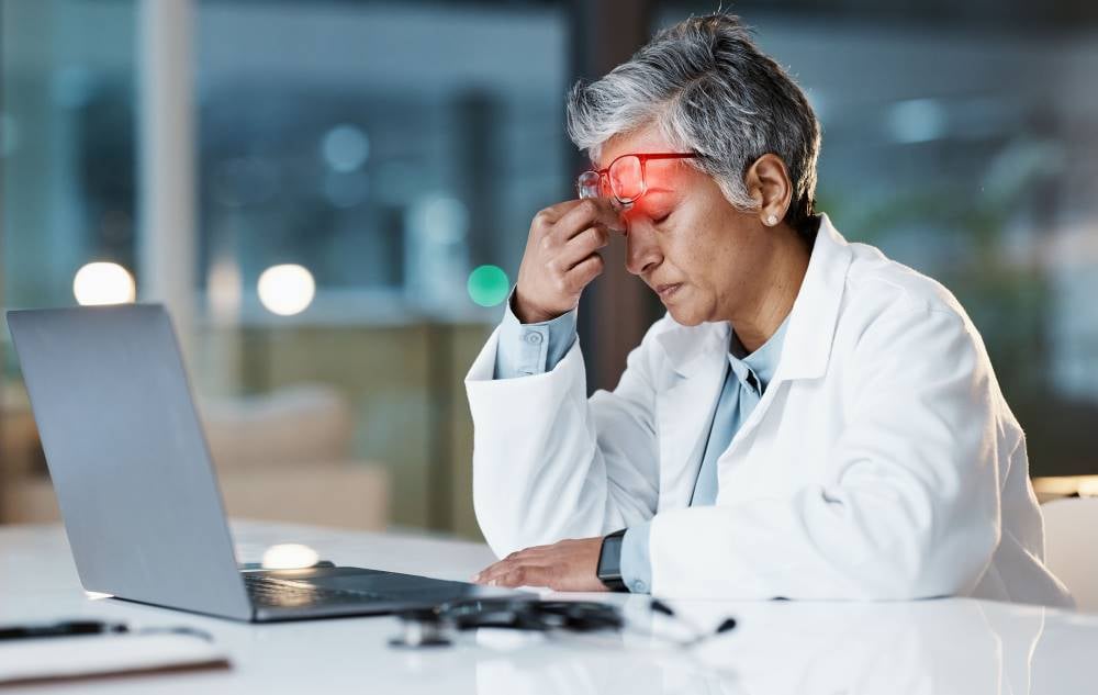 night-stress-headache-with-doctor-laptop-medical-thinking-deadline-review-burnout-accountability-mental-health-with-senior-woman-healthcare-medicine-science-research