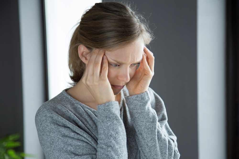 sick-woman-home-massaging-temples-feeling-strong-headache